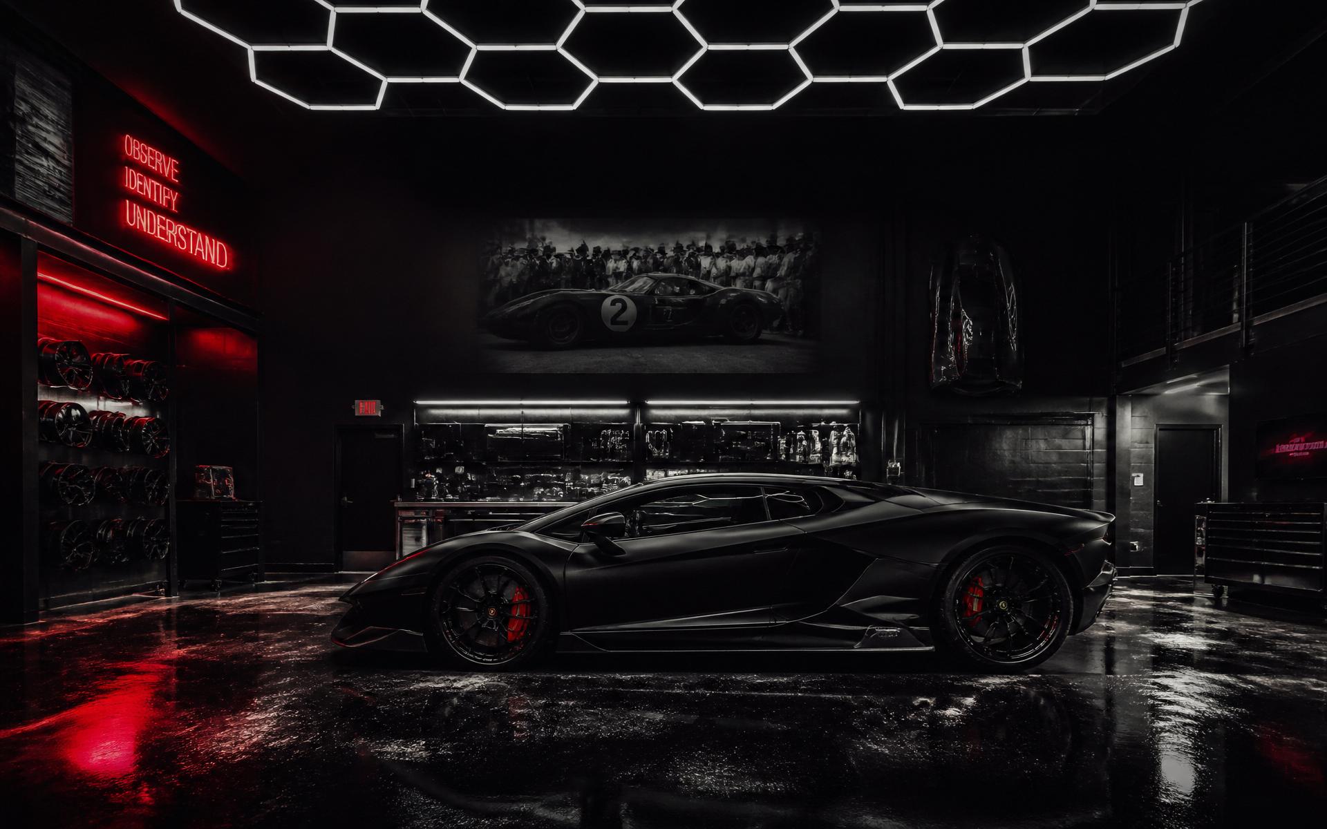 High Performance HQ workshop with matte black exotic supercar